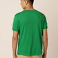 A person with short hair is facing away from the camera, wearing an Abundant Green Henley T-Shirt by Northmist and beige pants. The background is plain and light-colored.